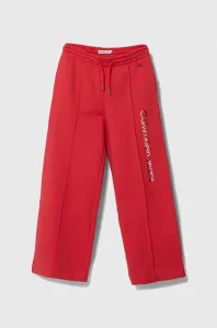 Detské bavlnené tepláky Calvin Klein Jeans červená farba, s potlačou