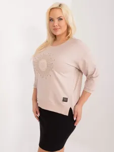 A beige blouse of a larger size with rhinestone appliqué