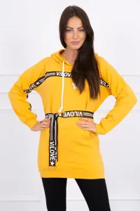 Dress decorated with a tape with mustard inscriptions