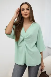 Oversized blouse with a light mint neckline
