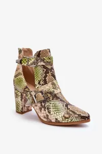 Fashionable shoes on a post with cutouts of beige-green suelo