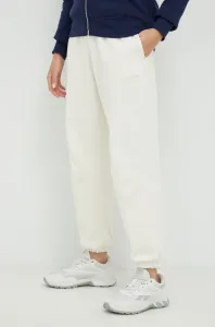 Bavlnené tepláky New Balance dámske, béžová farba, jednofarebné #5886907